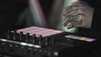 Click colored squares on mixer panel. ART. Hands in dark room are dialing code from multi-colored squares. Abstract music on mixer color board photo