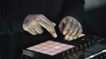 Click colored squares on mixer panel. ART. Hands in dark room are dialing code from multi-colored squares. Abstract music on mixer color board photo