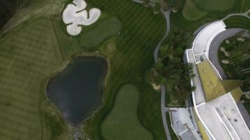 Top view green golf course outdoor green grass field. Aerial view from flying drone photo