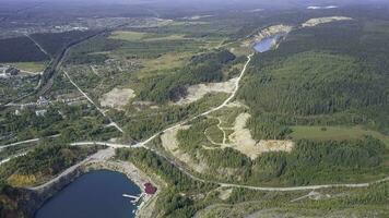 Beautiful mountain pond and forest aerial view. Clip. Pond in the stone quarry photo