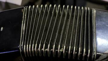 Playing on a big accordion. Playing the harmonica close-up. Old musical instrument Russian bayan - button accordion close-up photo