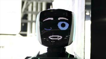 gracioso robot con grande azul ojos sonriente, hablando, y parpadeo . meida. cerca arriba de robot cara pantalla con simpático sonrisa a el exposición de moderno tecnologías. foto