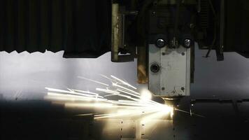 Laser machine cutting of sheet metal. Clip. Sparks fly from laser by automatic cutting CNC, PLC machine photo