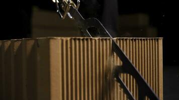 Close up of a worker using a block cutting automatic saw to prepare ceramic blocks for building process. Stock footage. Turned on small electric saw. photo