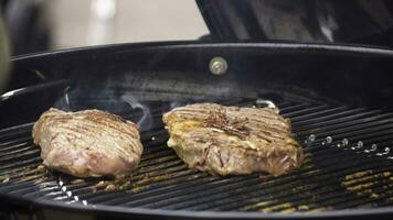 Beef steaks on the grill with flames. Cooking steaks on the coals. Concept of eating meat photo