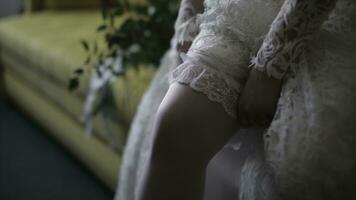 Bride dresses stockings on feet. Beauty bride in a dress wearing stockings wedding indoors. Female portrait nice lady in a dress. Closeup of woman hands photo