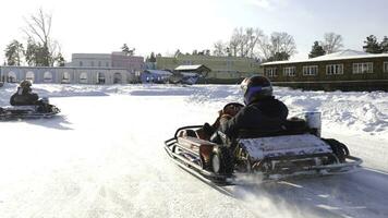 Winter competitions of kart racing on the ice of road. Go kart in winter photo