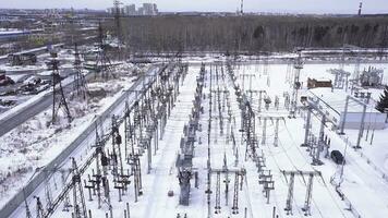 Rows of electric poles of substation. Action. Top view of small electrical substation with rows of transformers in suburbs. Suburban electric substation in winter photo