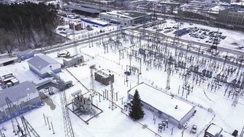 Top view of electric city substation. Action. Electrical substation with transformers distributing high voltage throughout city. Suburban electric substation in winter. Electric power industry photo