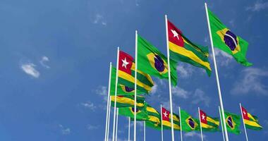 Togo and Brazil Flags Waving Together in the Sky, Seamless Loop in Wind, Space on Left Side for Design or Information, 3D Rendering video