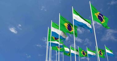 Sierra Leone and Brazil Flags Waving Together in the Sky, Seamless Loop in Wind, Space on Left Side for Design or Information, 3D Rendering video