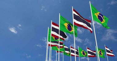 Thailand and Brazil Flags Waving Together in the Sky, Seamless Loop in Wind, Space on Left Side for Design or Information, 3D Rendering video