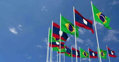 Laos and Brazil Flags Waving Together in the Sky, Seamless Loop in Wind, Space on Left Side for Design or Information, 3D Rendering video