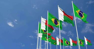 Madagascar and Brazil Flags Waving Together in the Sky, Seamless Loop in Wind, Space on Left Side for Design or Information, 3D Rendering video