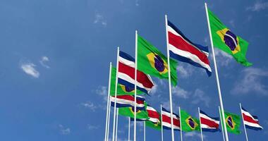 Costa Rica and Brazil Flags Waving Together in the Sky, Seamless Loop in Wind, Space on Left Side for Design or Information, 3D Rendering video