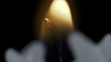 White long candle on black background. Single candle flame light. Long flame, old candle. White candle, black background. White glossy cylinder unlighted isolated on a dark background photo