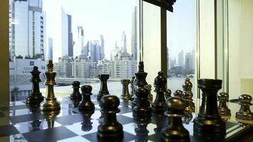 Black and gold chess close up with city landscape with skyscraper background. Business strategic formation in the chess game with city background photo