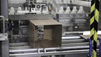 Cardboard boxes on conveyor belt in factory. Clip. Cardboard boxes on conveyor belt in factory photo