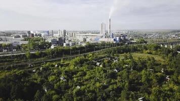 Top view of city's industrial district in summer. Stock footage. Industrial plants, businesses and warehouses located in suburbs in summer photo