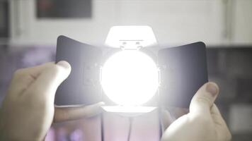 Close up of hands touching blades of tracking light. Action. Male hands making diffused light instead of spot light, electric illumination of the room. photo