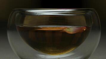 Close up cup of tea and mint on a wooden background. Glass of hot tea close up. Bowl of Chinese tea extreme close up photo