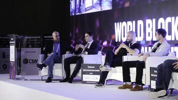 United Arab Emirates, Dubai - October 2017. Business Meeting and Conferences Ideas. Group of People Attending Conference and Listening to the Host Speakers On Stage. Conference in Dubai on blockchain photo