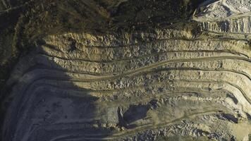 Panoramic view of quarry. Shot. Top view of picturesque quarry located on coastal mountain near village in forest. Concept of mining photo