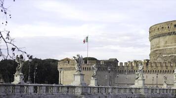 Italian Flag, Italy. Stock. Flag of Italy on the wall of the St. Angel Castle against the sky. View of the Italian flag, rippling on the walls of the old castle photo