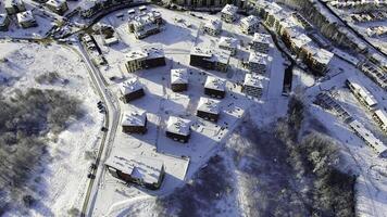 Top view of the city in winter with snow on the roofs on a Sunny day. Motion. Beautiful Sunny day in the city in winter photo