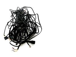 Tangled roll of black wires isolated on white background. Clip art. E-waste mess concept. photo