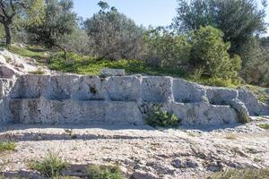 Seven Seats Plateau Monument or Seven Thrones Plateau ruins on Philopappos Hill,  landmark in Athens, Greece photo