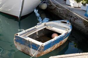 Little Old fishing boat in the port on the Island of Aegina, Greece photo