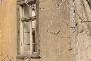 Old abandon home with broken window that can be found throughout the city in Athens, Greece photo