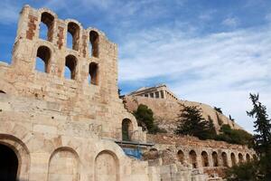 View of part of the Odeon of Herodes Atticus Theater foreground and the Parthenon in background photo