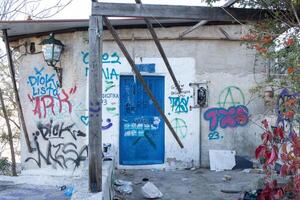 Athens, Greece, December 15 2023 Colorful but unlawful graffiti plastered on walls and city building in Athens photo