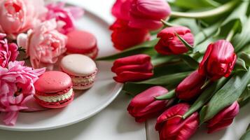 AI generated A white plate topped with pink and red macaroons next to a bouquet of red and pink tulips photo