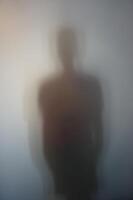 Man Silhouette Behind Frosted Glass photo