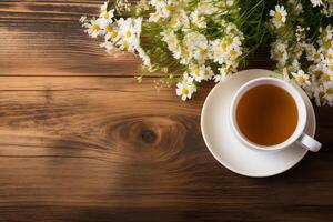 ai generado taza de té y manzanilla flores en de madera antecedentes foto