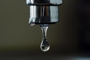 AI generated Faucet with drop of water, close up of water drop photo