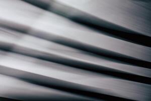 Abstract horizontal striped background with smooth lines and highlights in black and gray tones. photo