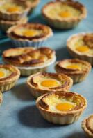 AI generated A table filled with delicious mini pies topped with eggs photo