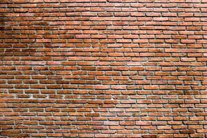 Brick wall or red brick dark tone of color for background texture photo