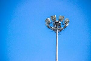 Street light bulb LED type and white pole high on the road and blue sky for electric texture and background photo