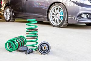 Spring suspension with seal rubber part and blur car background for texture and copy space maintenance and service concept photo