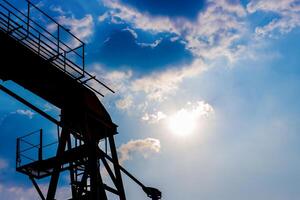 Shadow image of overhead crane rail walkway and blue sky in afternoon time photo