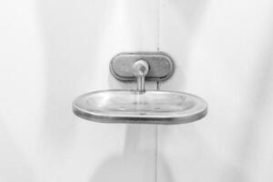 Soap tray used in bathroom have a stain and  Stone tiles with light image hotel concept photo