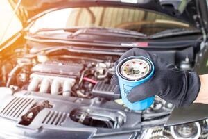 Close up hand a man put oil filter for car maintenance concept in engine room photo