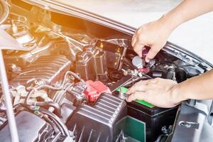 Hand a man use screw driver adjust level headlights of car in the engine room service concept photo