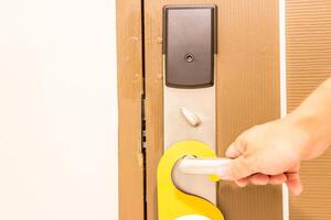 Door knob Armrest style and hand a man lock action in the rent room of hotel photo