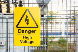 High Voltage Warning Signs yellow mark on the wire mash wall safety concept for  people photo